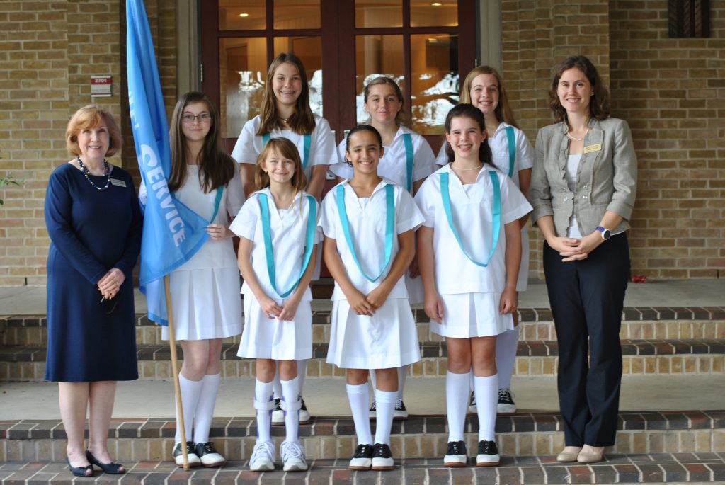 Two teachers and 7 students from Saint Mary's Hall stand and pose for photo