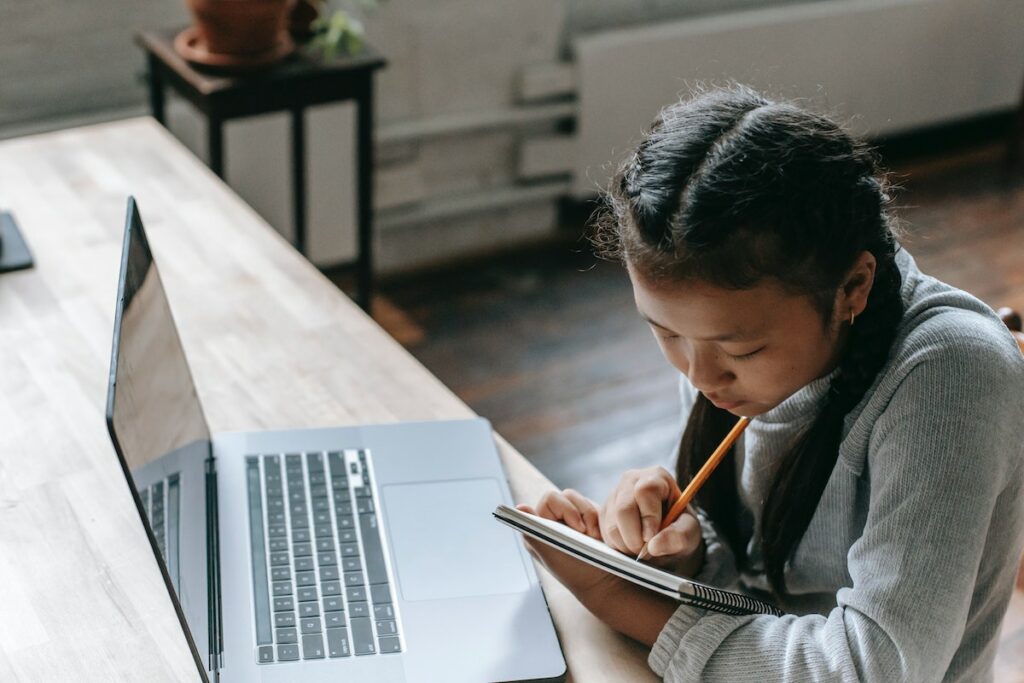 Girl with notepad and computer